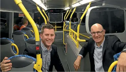  ??  ?? North Shore councillor­s Richard Hills, left, and Chris Darby caught the first ever double-decker bus along Onewa Rd.