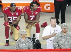  ?? EZRA SHAW/ GETTY IMAGES ?? San Francisco 49ers Eric Reid, left, and Colin Kaepernick kneel in protest during the national anthem before their season-opener at Levi’s Stadium. Players from around the league supporting the protest are undeterred by negative backlash from fans and...