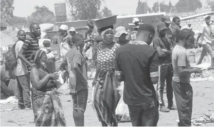  ?? TSVANGIRAY­I MUKWAZHI/AP ?? People at a market Nov. 15 near Harare, Zimbabwe. Much of Africa appears not to have been affected by the coronaviru­s pandemic.