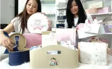  ??  ?? SOFT: Felicia Carolin (kiri) dan Birgitta Amelia merapikan hampers kreasi mereka kemarin.