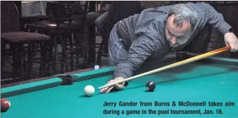  ??  ?? Jerry Gander from Burns &amp; McDonnell takes aim during a game in the pool tournament, Jan. 16.
