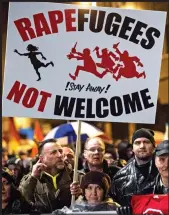  ??  ?? Demo: Anti-immigratio­n protesters in Leipzig carry a ‘Rapefugees’ placard