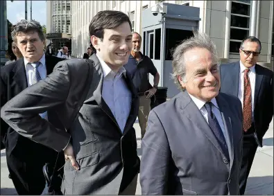  ?? Bloomberg News/PETER FOLEY ?? Former biotech chief executive Martin Shkreli (center left) follows his attorney Benjamin Brafman as they leave federal court Monday in Brooklyn, N.Y.