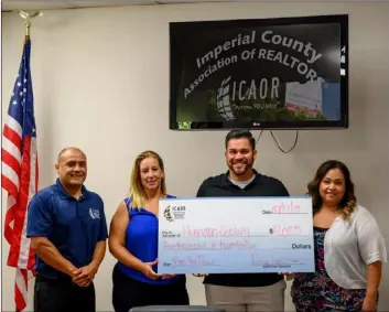  ?? COURTESY PHOTO ?? Humane Society of Imperial County executive director Devon Apodaca (second from right) receives a $4,025 donation from the Imperial County Associatio­n of Realtors on Wednesday.