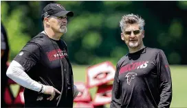  ?? CURTIS COMPTON / CCOMPTON@AJC.COM ?? Falcons head coach Dan Quinn (left) and general manager Thomas Dimitroff take in the first day of rookie minicamp Friday in Flowery Branch.