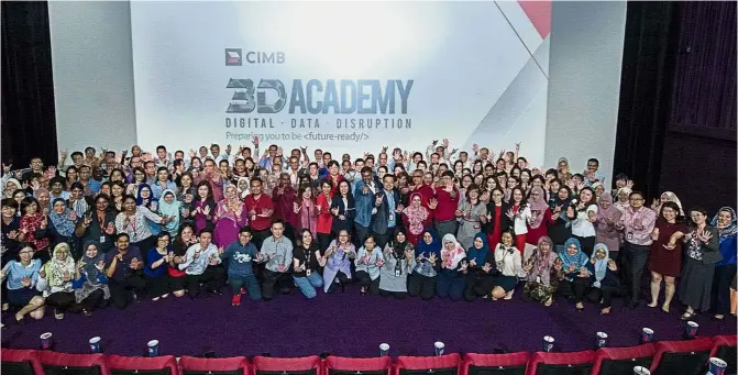  ??  ?? CIMB Group Group Chief People Officer Datuk Hamidah Naziadin (centre, in black) and Group Chief Technology and Operations Officer Ramesh Narayanasw­amy (centre, in grey) together with CIMB staff at the launch of the Academy.