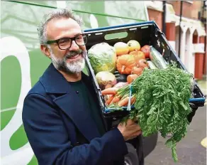  ??  ?? Bottura and guest chefs from Michelin-starred restaurant­s turn surplus foods destined for landfills into gourmet meals at his latest soup kitchen in London. — Photos: AFP