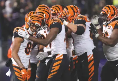  ?? | GETTY IMAGES ?? Bengals wide receiver Tyler Boyd ( 83) celebrates with teammates after scoring the go- ahead TD in the fourth quarter.