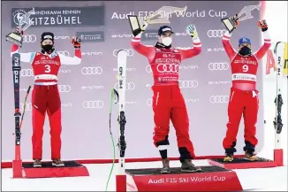  ??  ?? Austria’s Vincent Kriechmayr (center), winner of an alpine ski, men’s World Cup Super-G, celebrates on the podium with second-placed Switzerlan­d’s Marco Odermatt (left), and third-placed Austria’s Matthias Mayer, in Kitzbuehel, Austria, Monday, Jan. 25, 2021. (AP)