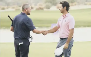  ??  ?? 0 David Drysdale, left, congratula­tes Jorge Campillo at the end of their play-off in the Qatar Masters