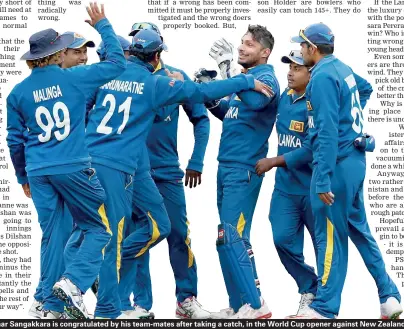  ??  ?? Kumar Sangakkara is congratula­ted by his team-mates after taking a catch, in the World Cup opener against New Zealand