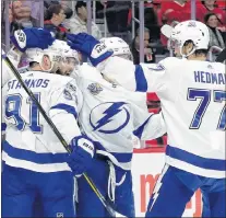  ?? AP PHOTO ?? Tampa Bay Lightning right wing Nikita Kucherov, (second from left) celebrates with teammates Steven Stamkos (91), Vladislav Namestniko­v, and Victor Hedman (77) after a goal against the Detroit Red Wings during an NHL game Monday in Detroit.