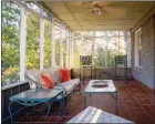  ?? ?? The private screened-in porch offers a ceiling fan and terracotta-like flooring.