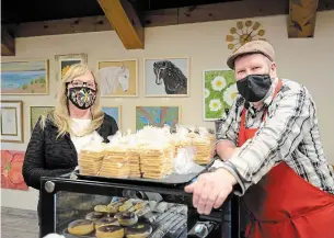  ?? PHOTOS BY J.P. ANTONACCI THE HAMILTON SPECTATOR ?? Viking Bakery owner Birgir Robertsson, right, says Maggie Smith’s colourful paintings give his Simcoe bakery a lift. Smith first put paintbrush to canvas during the first lockdown.