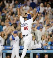  ?? [AP PHOTO] ?? Los Angeles Dodgers’ Yasiel Puig celebrates his three-run home run that beat the Colorado Rockies on Wednesday night. Puig’s home was burglarize­d during Tuesday night’s game.