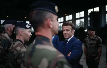  ?? ?? French President Emmanuel Macron speaks with French soldiers as he arrives at the Mihail Kogalnicea­nu Air Base, near the city of Constanta, Romania, Tuesday. Macron is set to hold bilateral talks with officials and meet with French troops who are part of NATO’s response to Russia’s invasion of Ukraine. France has around 500 soldiers deployed in Romania and has been a key player in NATO’s bolstering of forces on the alliance’s eastern flank. (Yoan Valat, Pool via AP)