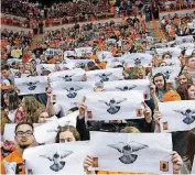  ?? ATHLETICS] [OSU ?? Oklahoma State fans hold up a newspaper page to taunt Oklahoma freshman Trae Young on Jan. 20 in Stillwater. Young has ornithopho­bia, an irrational fear of birds.