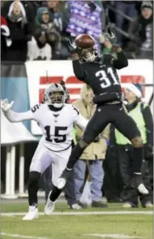  ?? MICHAEL PEREZ — THE ASSOCIATED PRESS ?? The Eagles’ Jalen Mills (31) breaks up a pass intended for the Raiders’ Michael Crabtree (15) during the second half Monday in Philadelph­ia.