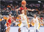  ?? TENNESSEE ATHLETICS PHOTO ?? Tennessee junior point guard Zakai Zeigler (5) totaled 20 points, eight assists and four steals during Saturday night’s 79-70 downing of North Carolina State in San Antonio.