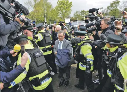  ?? PHOTOGRAPH: MARK MARLOW/EPA ?? ▼ Police usher Jeffrey Donaldson into court in Newry, where he faced charges of rape and gross indecency