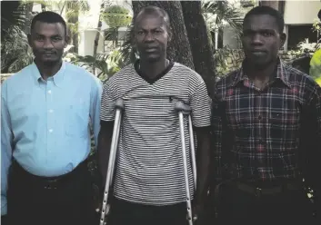  ?? COURTESY OF ELA MATTHEWS/CENTER FOR JUSTICE & ACCOUNTABI­LITY VIA AP ?? In this photograph provided by attorney Ela Matthews, (from left) David Boniface, Nissage Martyr and Juders Yseme pose together in 2014 in Haiti.