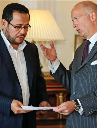  ??  ?? Six-year battle: Abdul Hakim Belhadj receives his letter of apology from British ambassador Dominick Chilcott in Istanbul yesterday