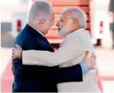  ??  ?? Prime Minister Narendra Modi greets his Israeli counterpar­t Benjamin Netanyahu at Ben-Gurion airport near Tel Aviv on Tuesday. — AFP