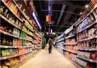  ??  ?? May 15, 2018: A customer shops for imported food at a supermarke­t in Nanchang City, Jiangxi Province. China serves as the largest importer of many commoditie­s for many countries globally. VCG