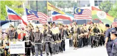  ??  ?? Members of Persatuan Bangsa Sungai Sabah (Sabas) dressed up in traditiona­l attire taking part in the National Day parade at Dataran Bandaraya yesterday. - Bernama photo