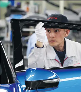  ?? TOMOHIRO OHSUMI/ BLOOMBERG FILES ?? A Toyota Motor Corp. worker inspects a Mirai fuel-cell vehicle at its plant in Japan. Toyota is joining the race to develop advanced technology through its partnershi­p with Mazda.