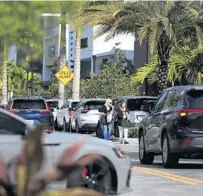  ?? CARLINE JEAN /SOUTH FLORIDA SUN SENTINEL ?? Patrons walk along with traffic at popular Uptown Boca shopping plaza in West Boca on Thursday.