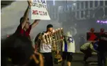  ?? ?? Police use water cannon to disperse anti-government demonstrat­ors in Tel Aviv, May 11th 2024