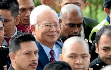  ?? AP ?? Former Malaysian Prime Minister Najib Razak, centre, arrives at a court house in Kuala Lumpur yesterday. He faces charges stemming from a corruption probe, two months after his shock election defeat.