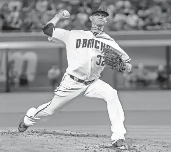  ?? BRIAN MUNOZ/ THE REPUBLIC ?? D-Backs starter Clay Buchholz pitches to the Pirates on Tuesday night at Chase Field.