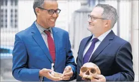  ?? PATRICK KOVARIK/GETTY-AFP ?? Scientist Jean-Jacques Hublin, right, and Abdelouahe­d Ben-Ncer, of the National Institute of Archaeolog­y in Morocco, pose with the casting of a Homo sapiens skull.