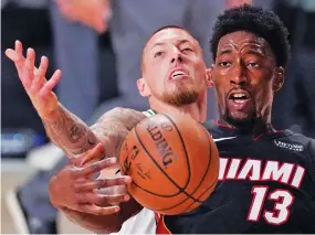  ?? MARK J. TERRILL/ASSOCIATED PRESS ?? Bam Adebayo of the Miami Heat is fouled by Daniel Theis of the Boston Celtics during the second half Sunday of their Eastern Conference final in Lake Buena Vista, Fla.