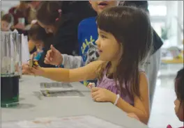  ?? NEWS PHOTOS MO CRANKER ?? Top: Saylee Mori makes some noise during a science experiment at the 27th annual Science Olympics.