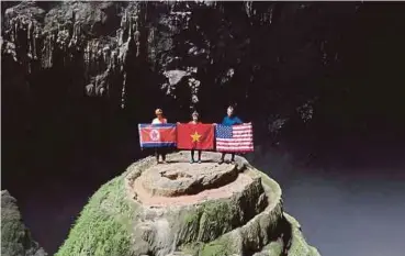  ?? EPA PIC ?? Tourists holding national flags of NorthKorea,Vietnam and the United States at the world’s biggest cave in Vietnam, Son Doong, in the Quang Binh province yesterday.