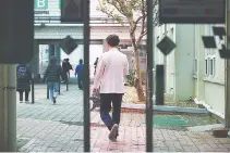  ?? REUTERS ?? A MEDICAL WORKER walks at Pusan National University Hospital in Busan, South Korea, Feb. 21.