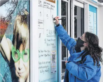  ?? PHOTO: STEPHEN JAQUIERY ?? Keeping track . . . Moana Pool receptioni­st Marie Smith counts people in and out of the Dunedin facility yesterday.