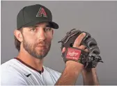  ??  ?? Diamondbac­ks pitcher Madison Bumgarner signed a five-year, $85 million contract with the club in December.