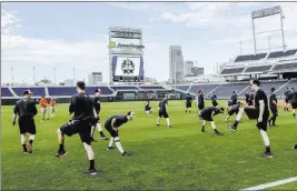  ?? Nati Harnik ?? The associated Press Oregon State players warm up at the start of team practice Friday in Omaha, Neb. At 54-4, Oregon State is on the cusp of all-time greatness.