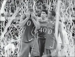  ?? By Robert Hanashiro, USA TODAY ?? Celebrator­y streamers, but not for us: From left, Kansas players Thomas Robinson, Kevin Young and Tyshawn Taylor leave the court after coming up short in the final.