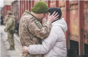  ?? (Inna Varenytsia/Reuters) ?? A UKRAINIAN SERVICEMAN says goodbye to his wife, who was visiting him during a short break from his frontline duty, at the train station in Kramatorsk, Ukraine, last week.