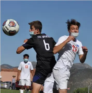  ??  ?? Above, East Mountain's Kyle Hofmann, No. 6, and a Hot Springs defender eyeing the ball after a corner kick. Below, Berkeley Flammang, No. 15 in blue, battling a Ruidoso defender. Photos by Ger Demarest.