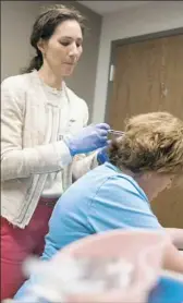  ??  ?? Dr. Santamaria injects several nerve blocks in Ms. Henthorn’s head targeting migraine trigger points to help control the condition.