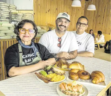  ?? PEDRO PORTAL pportal@miamiheral­d.com ?? Jesús Brazón, center, with his parents, Scarlet Rojas and Manuel Brazón, and some of the pastries and dishes available at their second Caracas Bakery in Miami. Manuel and Jesús Brazón, are semifinali­sts for a 2024 James Beard Award for outstandin­g pastry chef or baker.