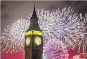  ?? AARON CHOWN AP ?? Fireworks light up the sky over the London Eye and Big Ben in London to ring in the new year.