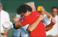  ?? MATT SULLIVAN / REUTERS ?? Rory McIlroy embraces his father, Gerry, after capturing the PGA Championsh­ip on Sunday, his second career major title.