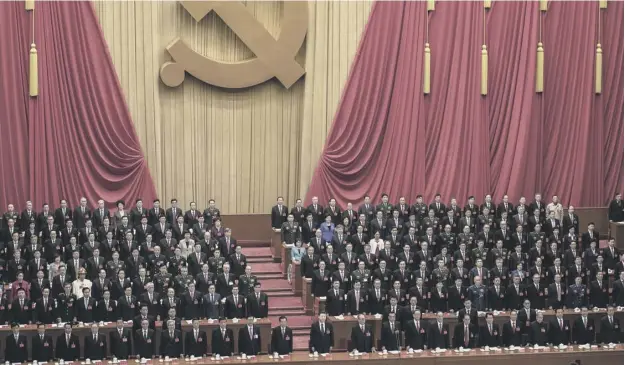  ??  ?? 0 Xi Jinping and senior members of the government stand during the national anthem prior to the opening session of the Communist Party Congress in Beijing